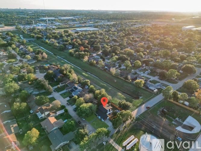 A bird's eye view of a residential area with a red marker indicating a specific location.