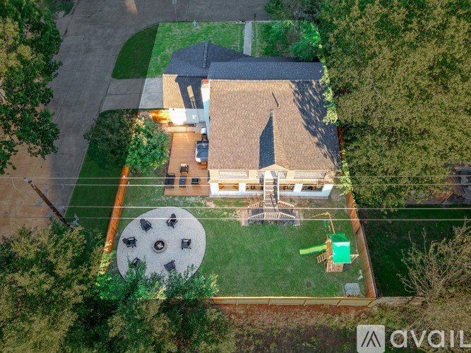 A house with a large backyard and a patio area.