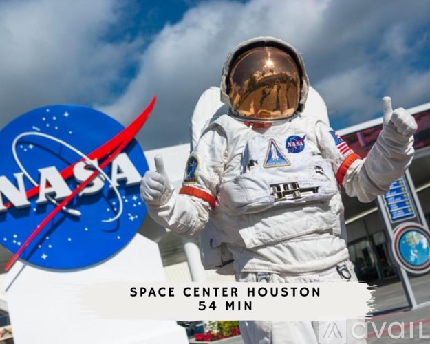 An astronaut in a spacesuit stands in front of the NASA logo.