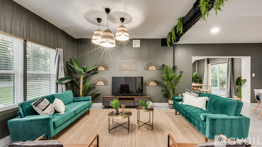A living room with a green couch and a wooden floor.
