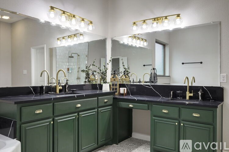 A bathroom with two sinks and a large mirror.