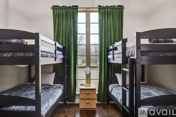 Three bunk beds in a room with green curtains.
