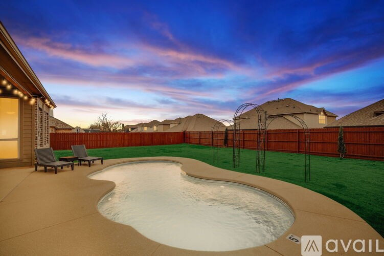 A backyard with a pool and a patio area.