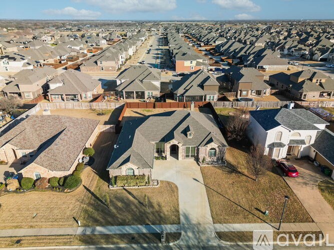 A row of houses with a car parked in front of the first house.