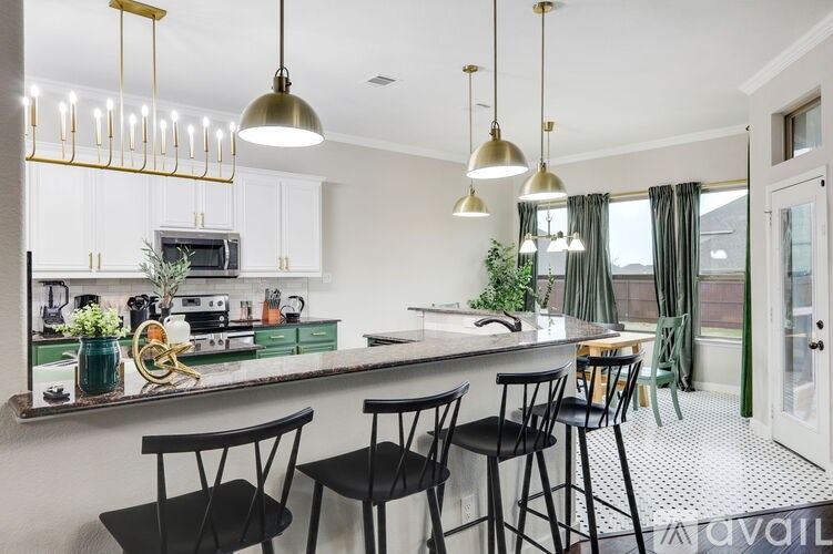 A kitchen with a bar area and a dining table.
