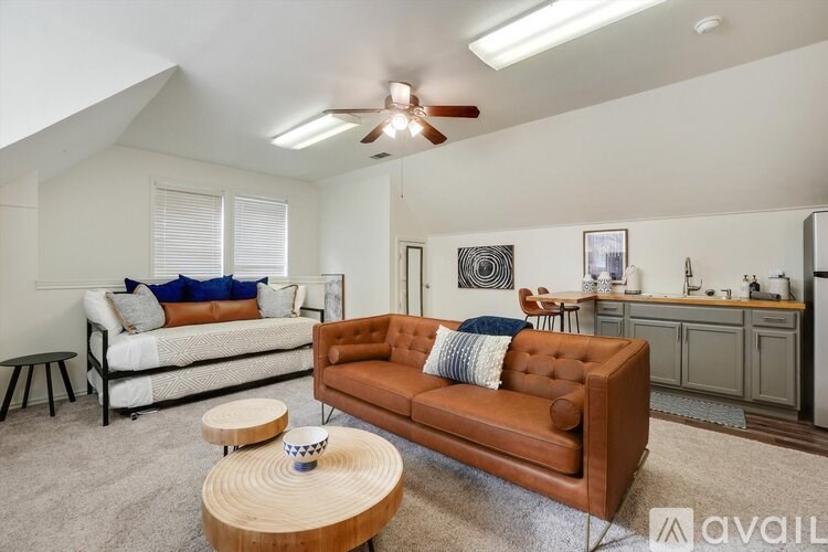 A living room with a brown couch and a wooden coffee table.