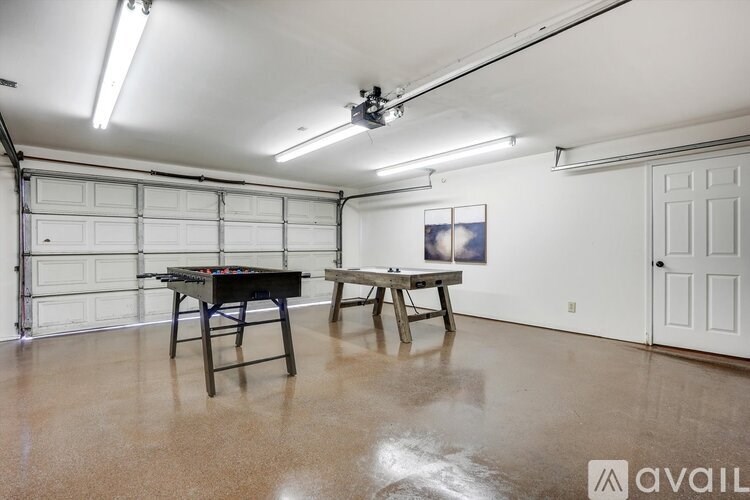 A room with a pool table and a bench.