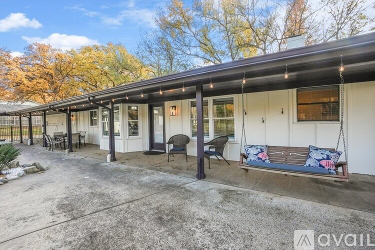 A porch with a swing and lights is shown.