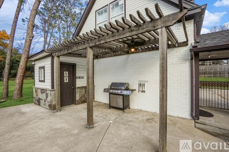 A house with a covered patio area and a grill.