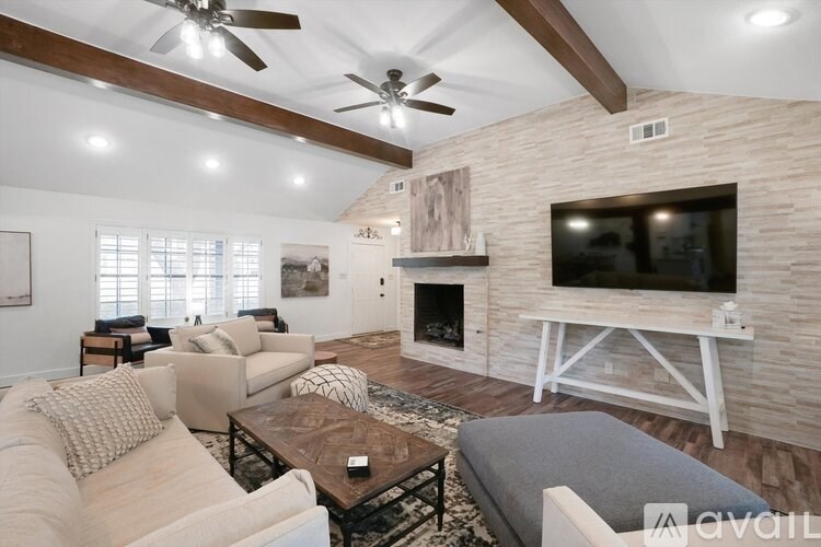 A living room with a fireplace and a television.