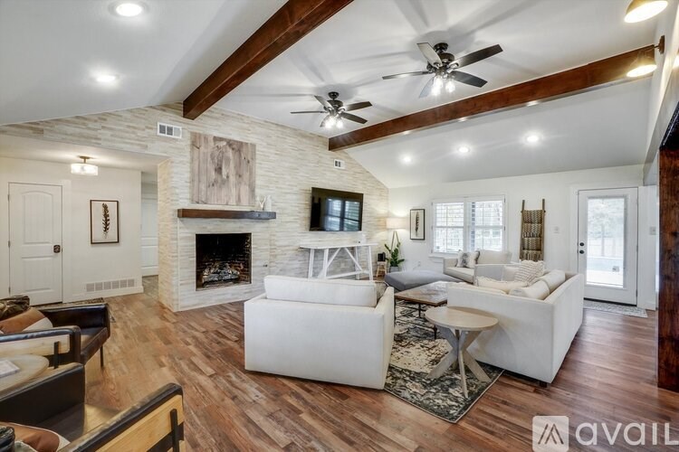 A living room with a fireplace and a white couch.