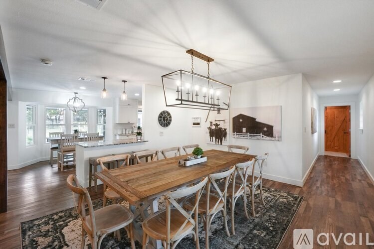 A modern dining room with a wooden table and chairs.