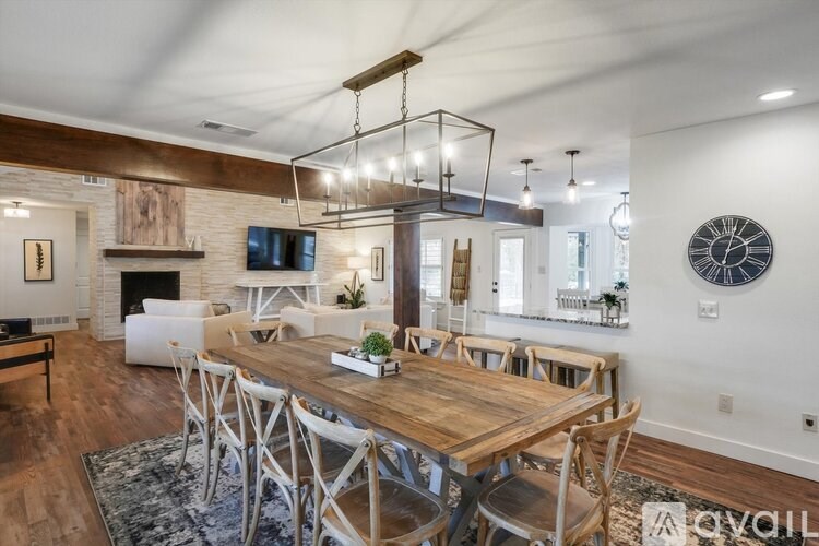 A modern dining room with a wooden table and chairs.