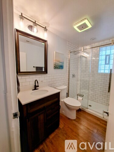 A bathroom with a white sink and a toilet.
