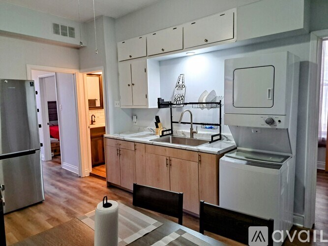 A kitchen with wooden floors and white appliances.