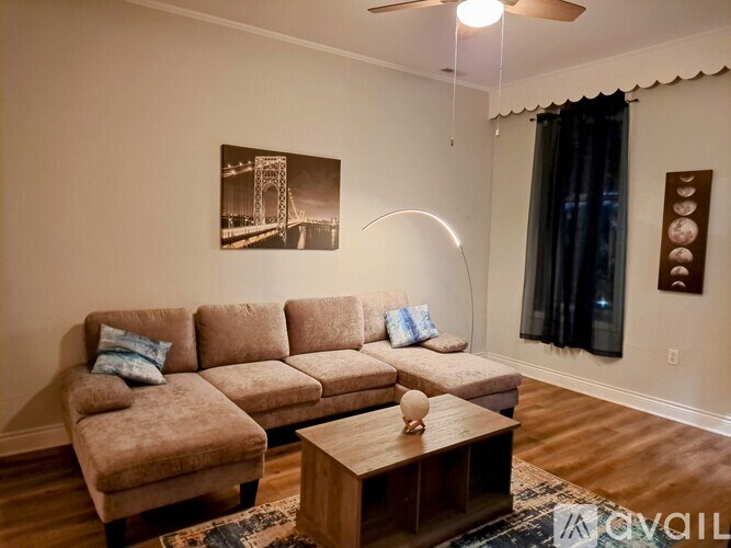 A living room with a large couch and a coffee table.
