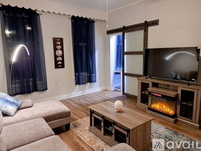 A living room with a fireplace and a television.