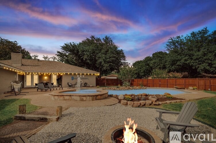 A backyard with a fire pit and a pool.