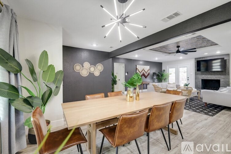 A modern dining room with a wooden table and chairs.
