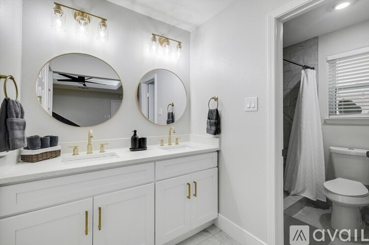 A bathroom with two sinks and two mirrors.