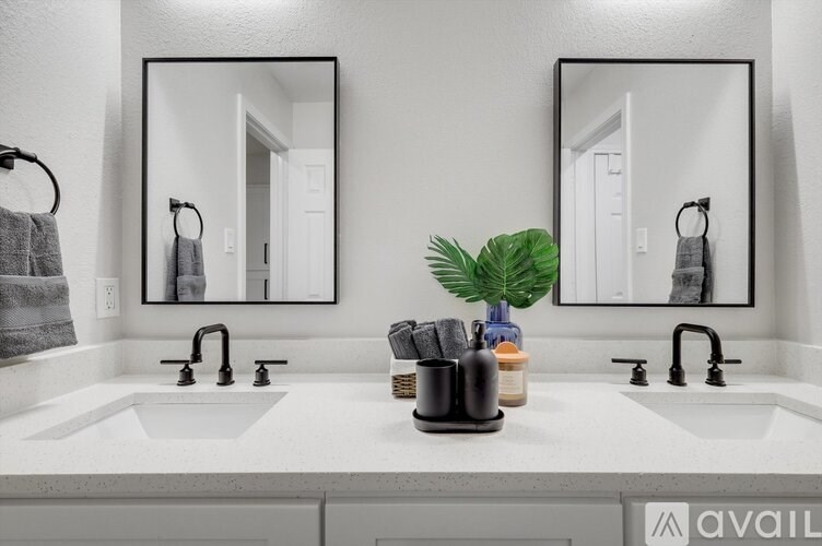 A bathroom with two sinks and two mirrors.