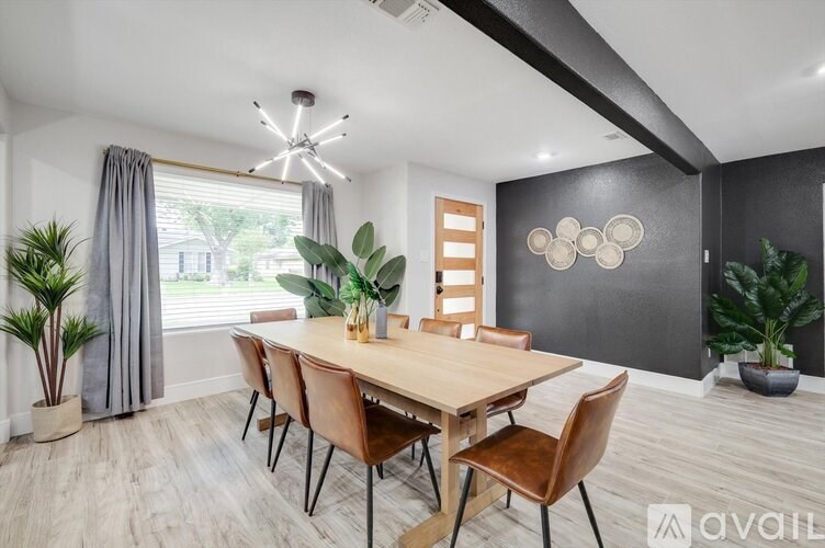 A dining room with a wooden table and chairs.