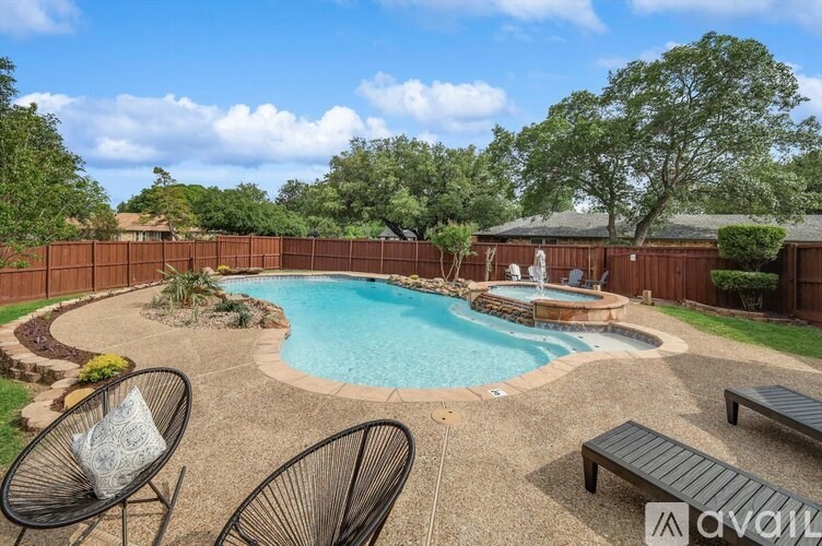 A backyard with a pool and patio furniture.