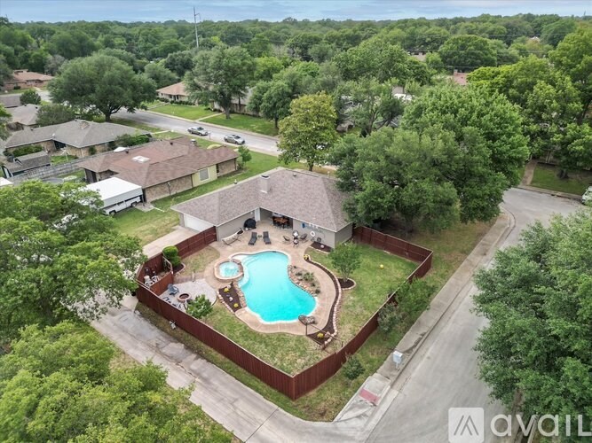 A backyard with a pool and a patio area.