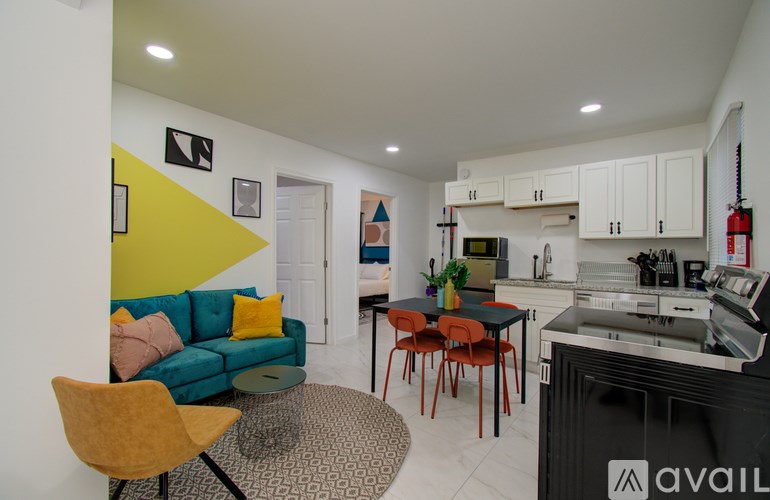 A kitchen with a black oven and white cabinets.