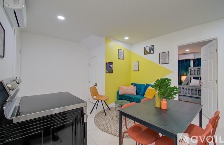 A living room with a yellow wall and a black table.