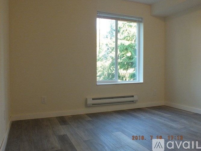 A room with a window and a wall-mounted air conditioner unit.