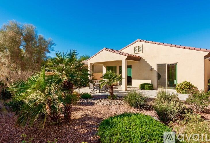 A house with a garden in front of it is for sale.