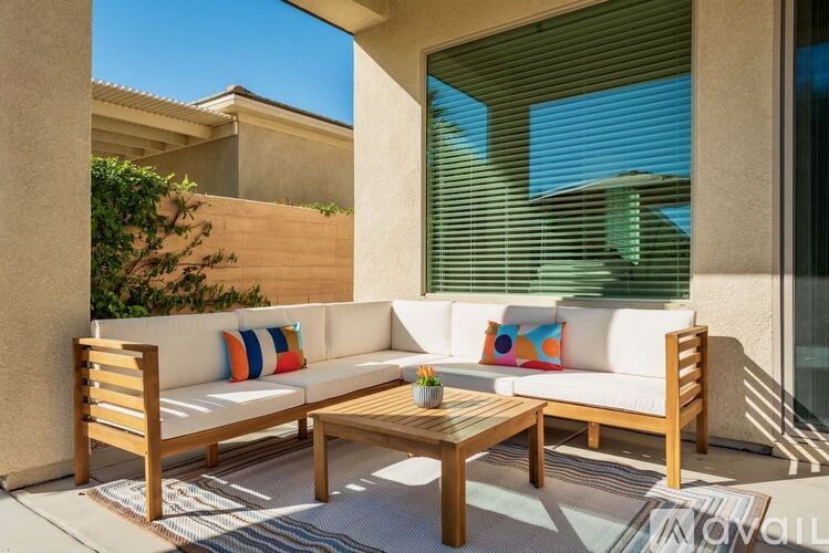 A wooden outdoor furniture set is placed on a patio.