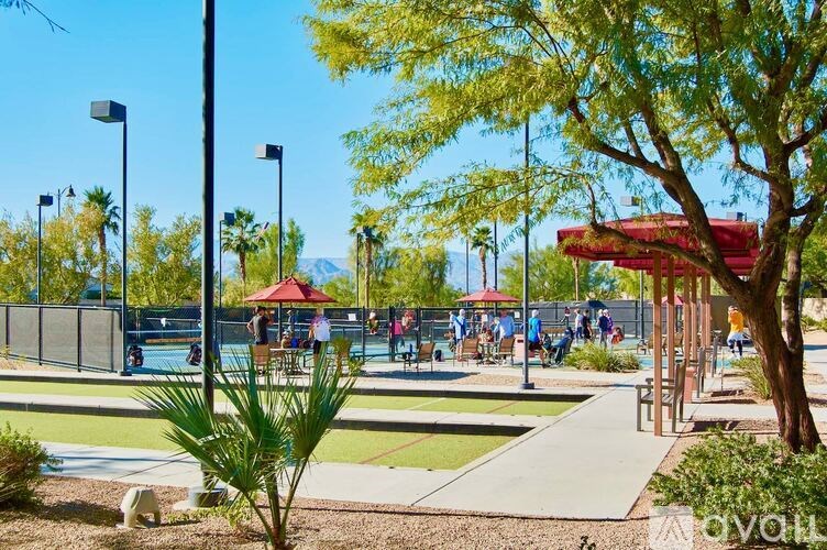 A sunny day at the park with people enjoying the outdoors.