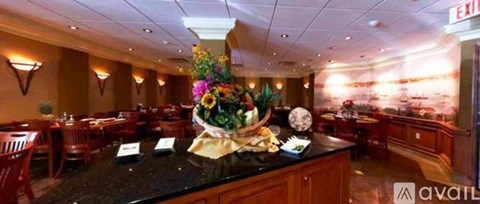 A restaurant with a large floral centerpiece on the table.