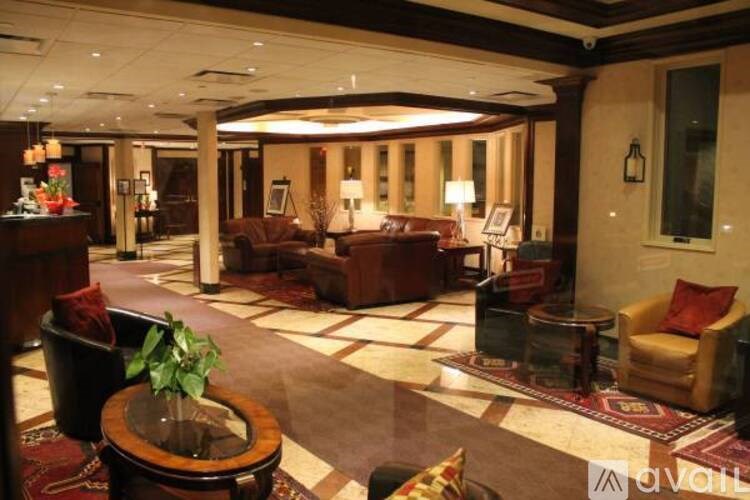 A large, well-lit lobby with a variety of seating options and a plant on a wooden table.