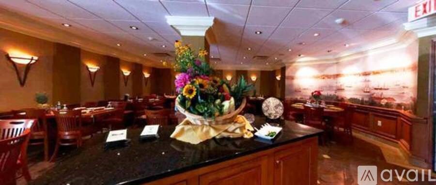 A restaurant with a large floral centerpiece on the table.