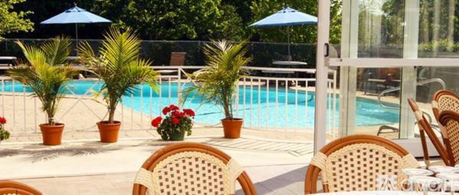 A poolside table with chairs and a glass table with chairs.