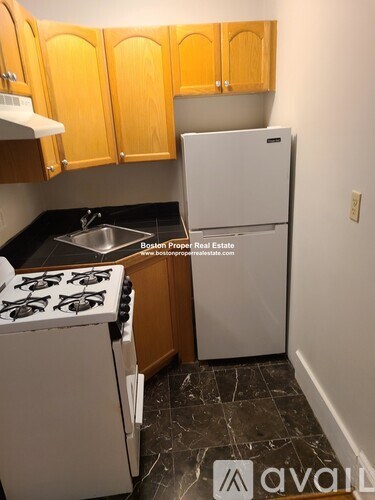 A kitchen with a white fridge and a white stove top.