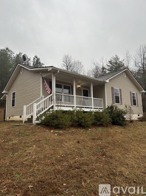 A house with a porch and an American flag on it.