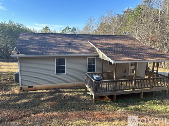 A house with a brown roof and a porch.