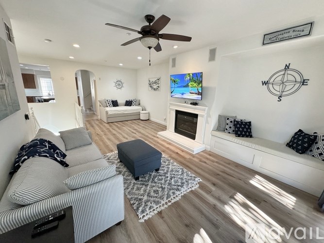 A living room with a fireplace and a flat screen TV mounted on the wall.