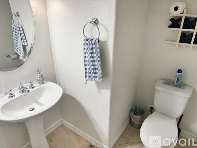 A white toilet sits next to a sink in a bathroom.