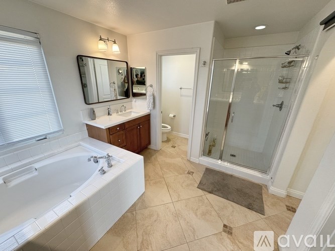 A bathroom with a white tub and a walk-in shower.