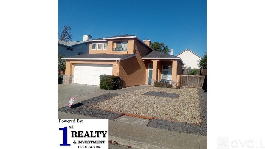 A house with a driveway and a sign that says "Powered by: 1st REALTY & INVESTMENT".