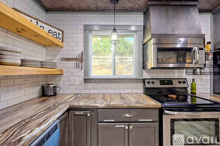 A kitchen with a wooden counter top and a stove with a pot on it.