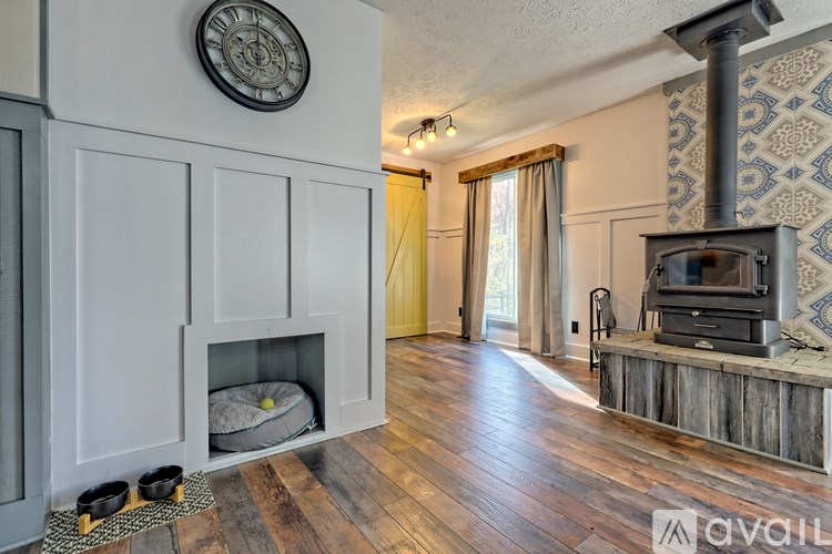 A living room with a fireplace and a television.