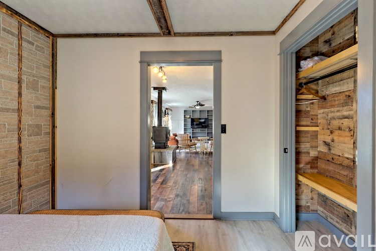 A bedroom with a bed and a wooden wall.
