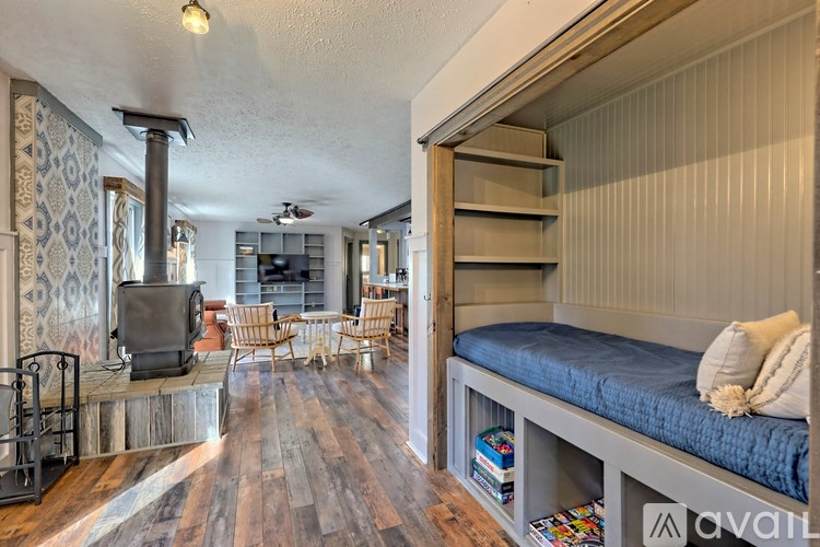 A living room with a wood floor and a television.