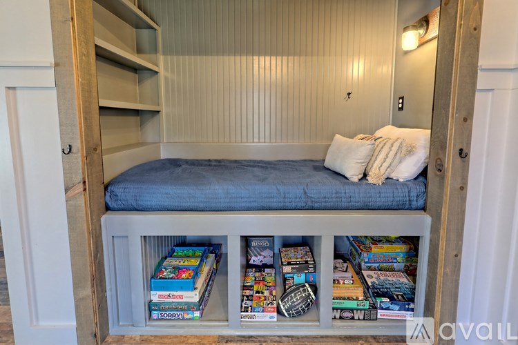 A small bedroom with a bed and a bookshelf.